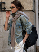 Washed Denim Jacket with a soft scarf on a stone street