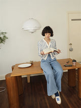 Slouch Flow Wide Denim in light blue, reading at a table