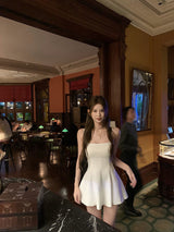 Frame Mini Dress in white in a restaurant lobby