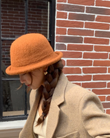 Rolled Brim Dome Hat in caramel against a brick wall
