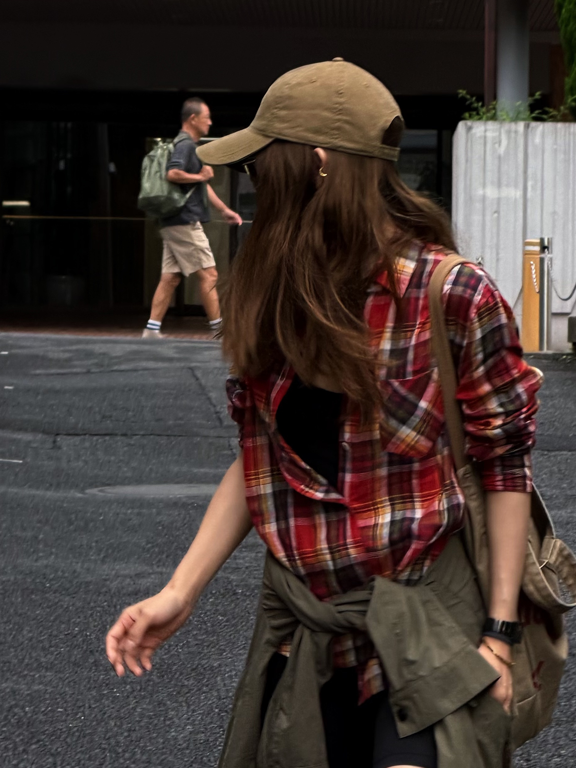 Red Plaid Linen Shirt with a jacket knotted at the waist, walking across the street