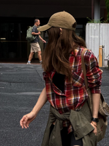Red Plaid Linen Shirt with a jacket knotted at the waist, walking across the street