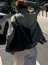 Back view of the Washed Denim Jacket on a sunny street