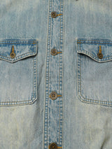 Close-up of the washed denim, chest flap pockets and metal buttons